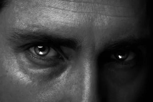 Man with captivating eyes, closeup. Black and white effect