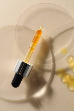 Bej arka planda nemlendirici serumu olan boru, üst görünüm.