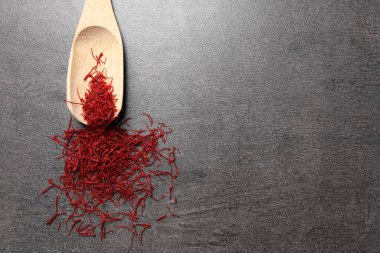 Aromatik safran ve ahşap kepçe gri masa, üst manzara. Metin için boşluk