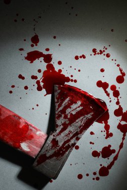 Gri yüzey üzerinde kan olan balta Karanlıkta, üst manzara