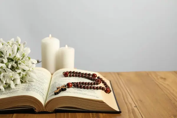 Bible Rosary Beads Flowers Church Candles Wooden Table Light Background — Stock Photo, Image