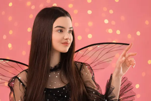 stock image Beautiful girl in fairy costume with wings on pink background