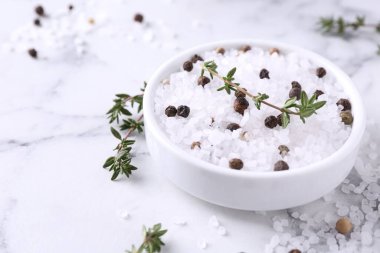 Kekikli tuz ve beyaz mermer masadaki kasede biber, yakın plan. Metin için boşluk