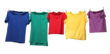 Çamaşır ipinde kurumuş renkli tişörtler beyazda izole edilmiş.