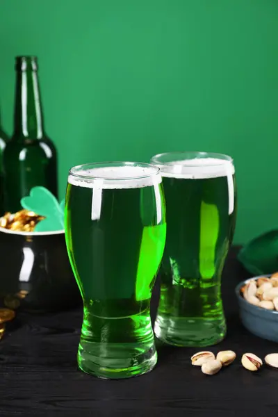 St. Patrick\'s day party. Green beer and pistachios on wooden table