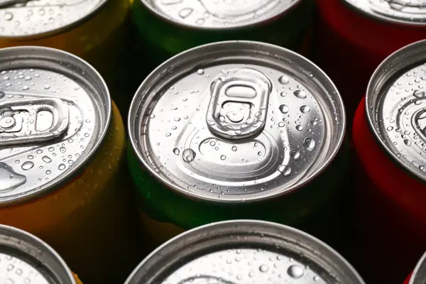 Energy drinks in wet cans, closeup. Functional beverage