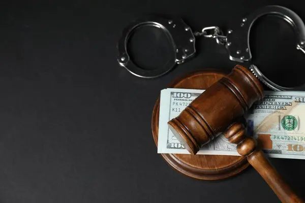 stock image Law gavel, dollars and handcuffs on grey table, flat lay. Space for text