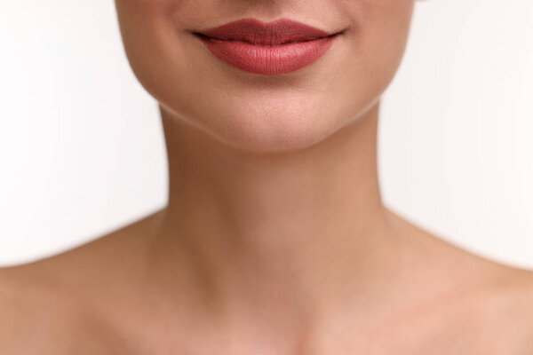 Woman with beautiful lips on white background, closeup