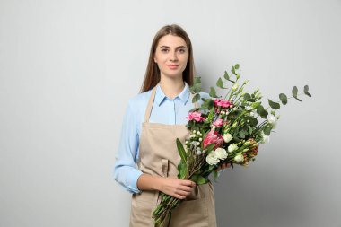 Açık arkaplanda güzel buketi olan bir çiçekçi.