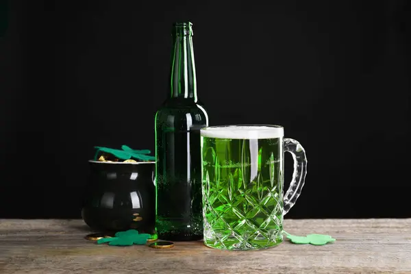 St. Patrick\'s day party. Green beer, leprechaun pot of gold and decorative clover leaves on wooden table