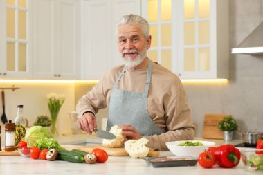 Mutfakta karnabahar kesen mutlu adam.