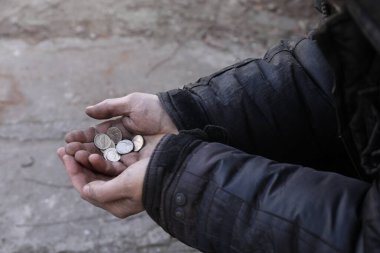 Dışarıda bozuk para tutan zavallı evsiz adam, yakın plan.