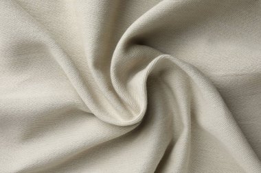 Arkaplan olarak bej buruşuk kumaş dokusu, üst görünüm