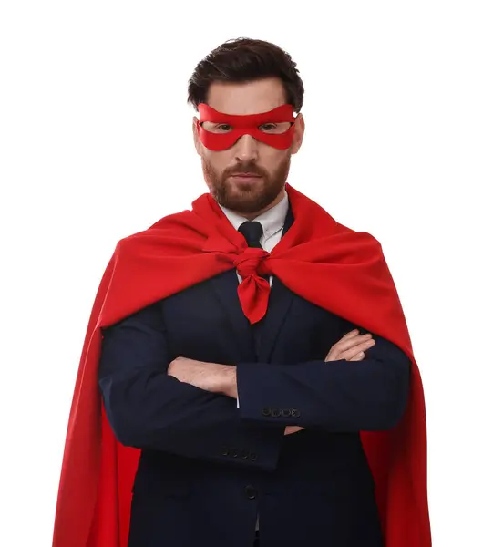 Confident businessman wearing red superhero cape and mask on white background