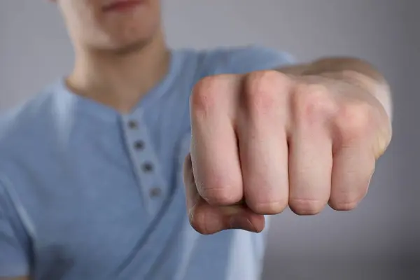 stock image Man showing fist with space for tattoo on grey background, selective focus
