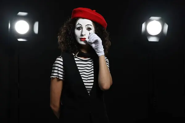 Young woman in mime costume performing on stage