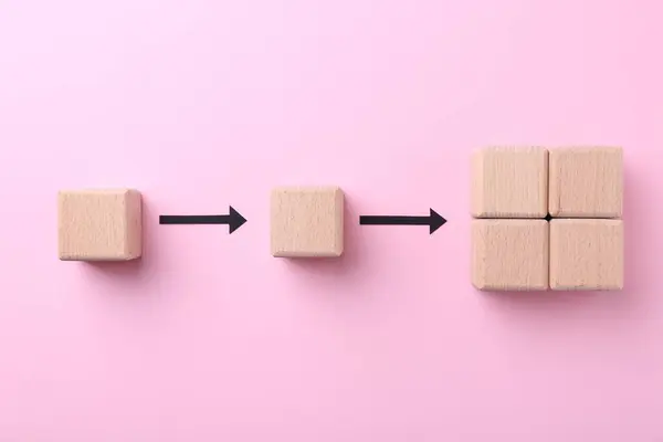 Business process organization and optimization. Scheme with wooden figures and arrows on pink background, top view