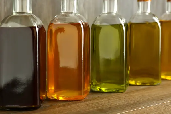 Vegetable Fats Different Oils Glass Bottles Wooden Table Closeup Royalty Free Stock Images