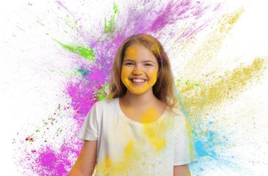 Holi festival celebration. Happy teen girl covered with colorful powder dyes on white background clipart