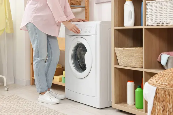 stock image Woman near washing machine in laundry room, closeup