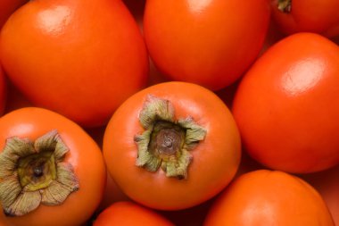 Delicious ripe juicy persimmons as background, closeup