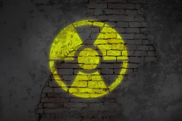 Radioactive sign on old brick wall. Hazard symbol