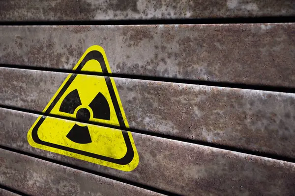 Radioactive sign on metal surface, space for text. Hazard symbol