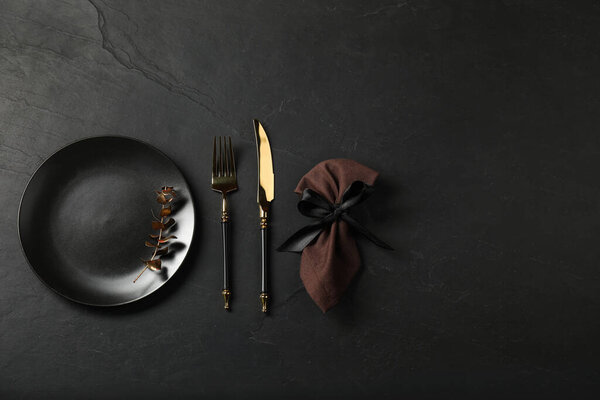 Stylish setting with elegant cutlery on grey textured table, flat lay. Space for text