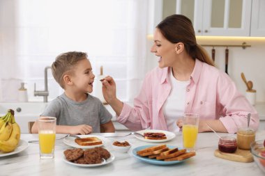 Annesi ve küçük tatlı oğlu mutfakta kahvaltı yapıyorlar.