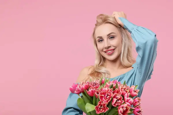 stock image Happy young woman with beautiful bouquet on dusty pink background. Space for text