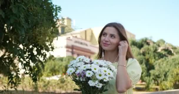 Mooie Jonge Vrouw Met Boeket Bloemen Genieten Van Muziek Tijdens — Stockvideo