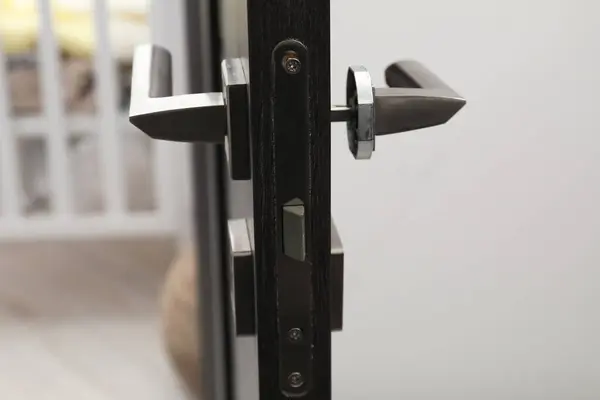 Wooden door with broken handle indoors, closeup