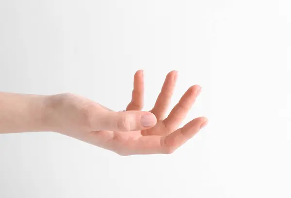Vrouw Houdt Hand Witte Achtergrond Close — Stockfoto