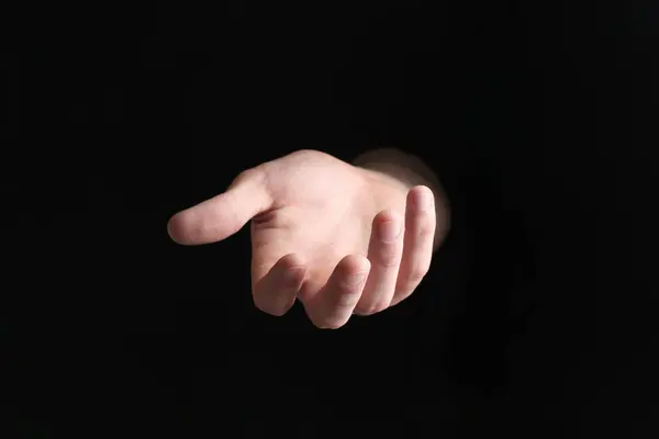 Man Met Iets Zijn Hand Zwarte Achtergrond Close — Stockfoto