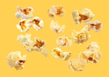 Turuncu arka planda uçan lezzetli patlamış mısır.