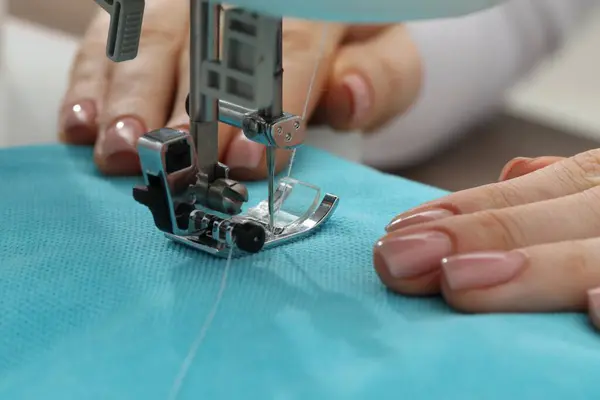 stock image Seamstress working with sewing machine indoors, selective focus