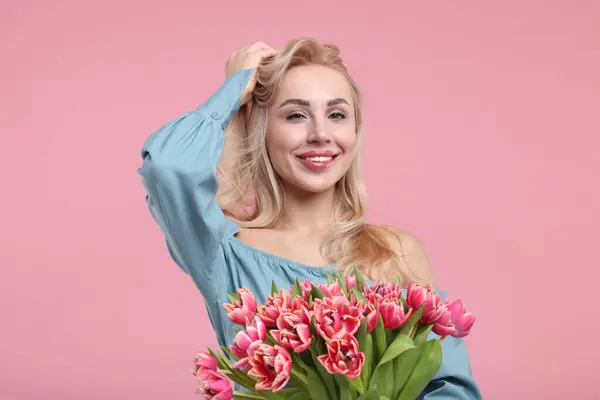 stock image Happy young woman with beautiful bouquet on dusty pink background