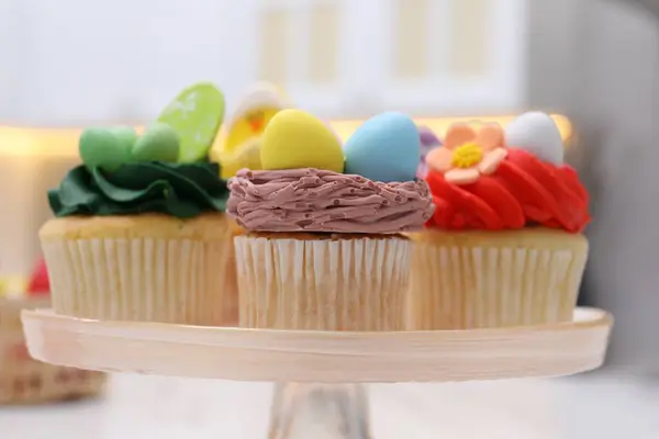 stock image Tasty decorated Easter cupcakes on stand, closeup