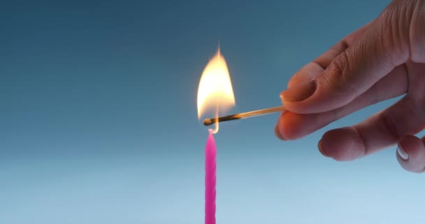 Woman Lighting Pink Festive Candle Light Blue Background Closeup — Stock Video