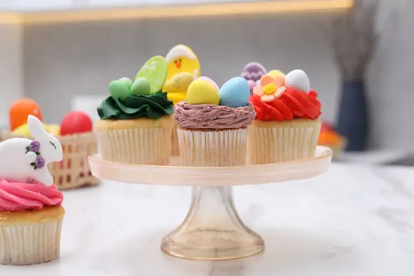 stock image Tasty decorated Easter cupcakes on white marble table