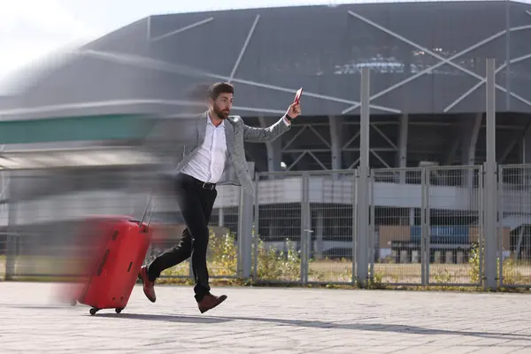 Being late. Businessman with suitcase and ticket running at station. Motion blur effect