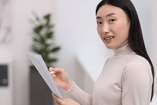 stock image Portrait of smiling businesswoman with documents in office