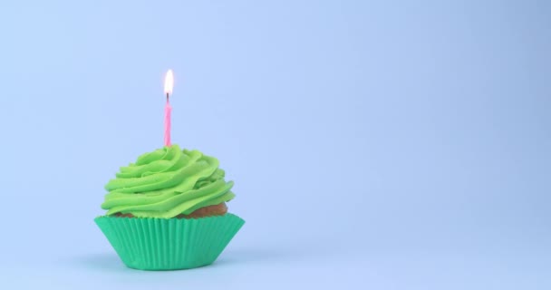 Smaklig Födelsedag Cupcake Med Brinnande Ljus Ljusblå Bakgrund — Stockvideo