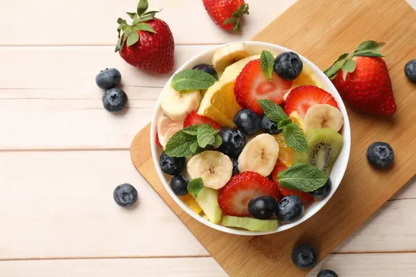 Tasty Fruit Salad Bowl Ingredients Wooden Table Flat Lay Space — Stock Photo, Image