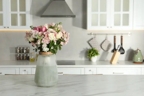 Beautiful bouquet of fresh flowers in vase on table indoors, space for text