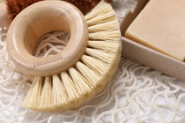 stock image Cleaning brush and soap bar on table, closeup