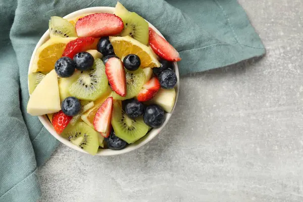 Tasty Fruit Salad Bowl Gray Textured Table Top View Space — Stock Photo, Image