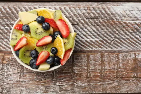 Tasty Fruit Salad Bowl Wooden Table Top View Space Text — Stock Photo, Image
