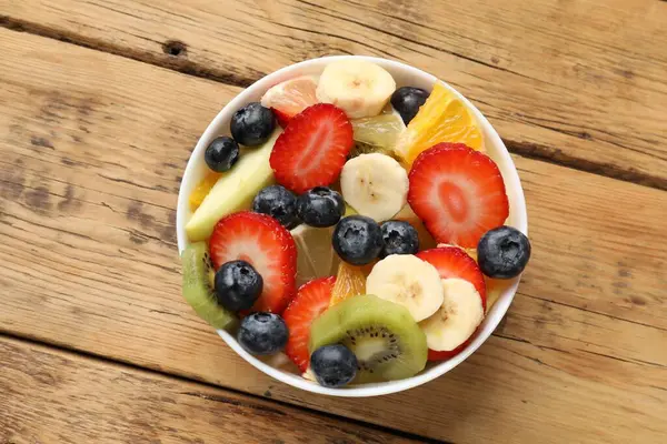 Tasty Fruit Salad Bowl Wooden Table Top View — Stock Photo, Image
