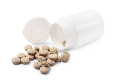 Beyaza izole edilmiş vitamin hapları ve şişe.